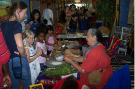 Anita showing children the types of foods that Lipan Apaches ate.